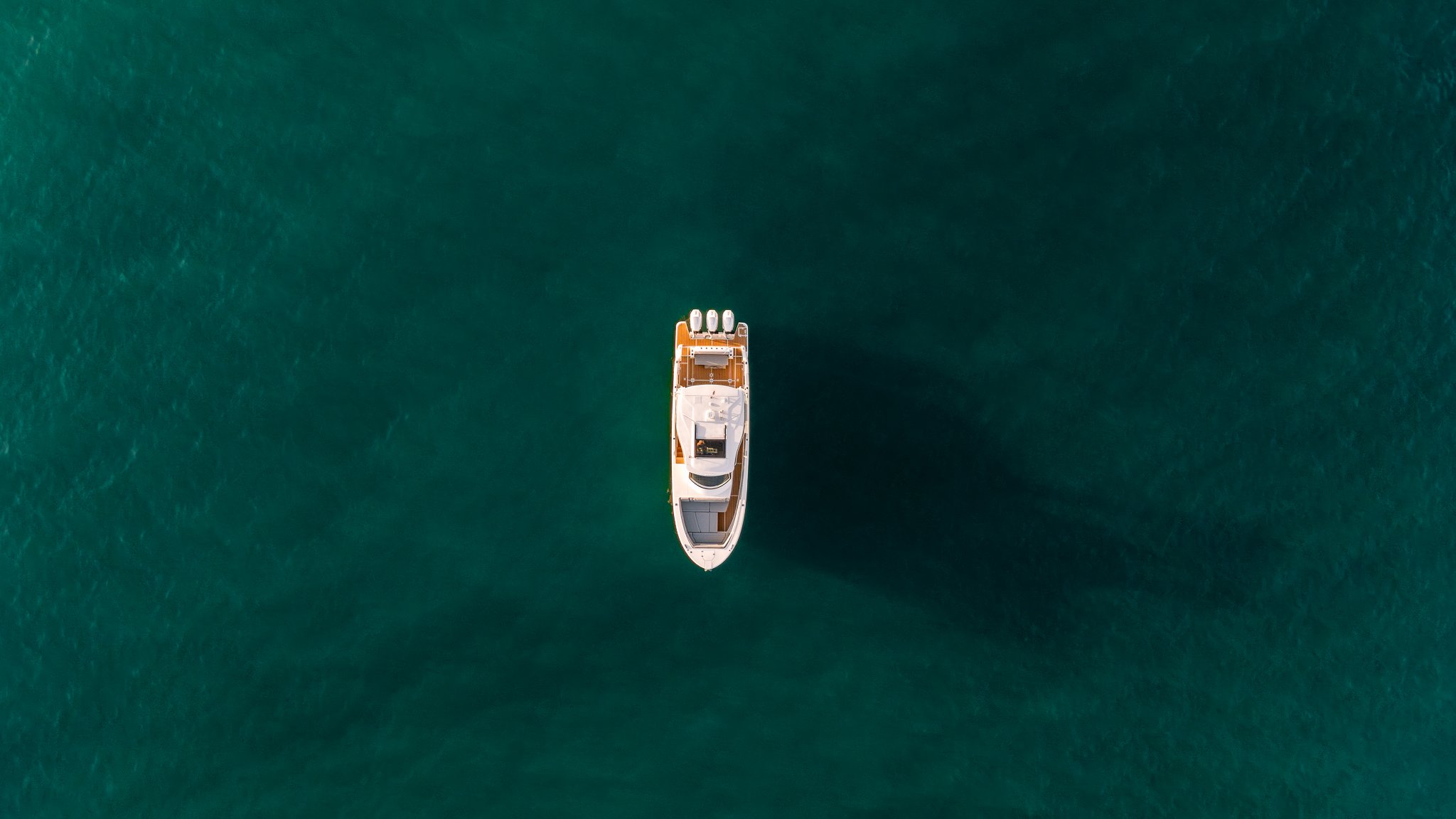 Aerial drone shot of a Regal boat on emerald water